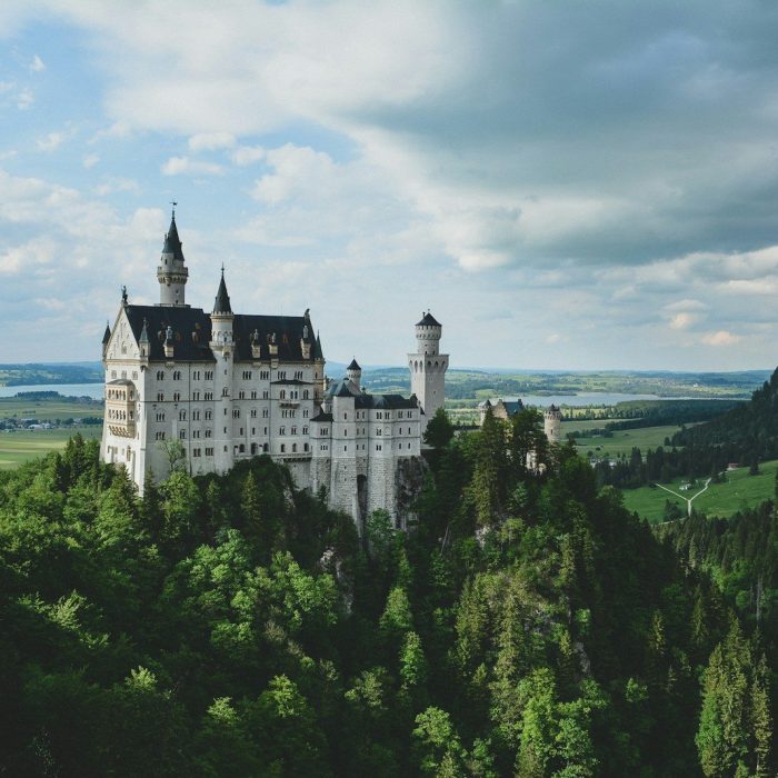 white concrete castle in green field